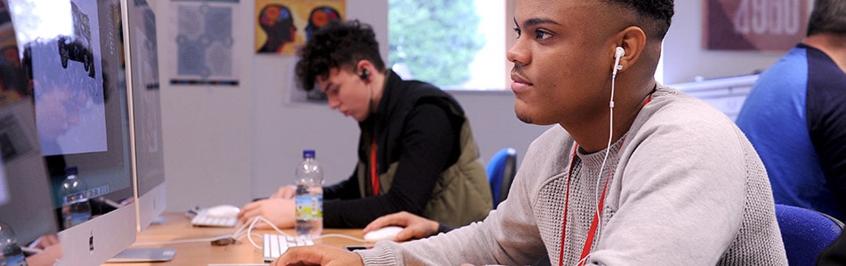 student listening to music whilst sat at desk